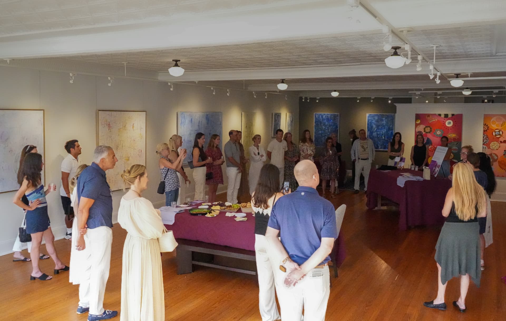Wide view of guests gathered in the gallery during the reception program