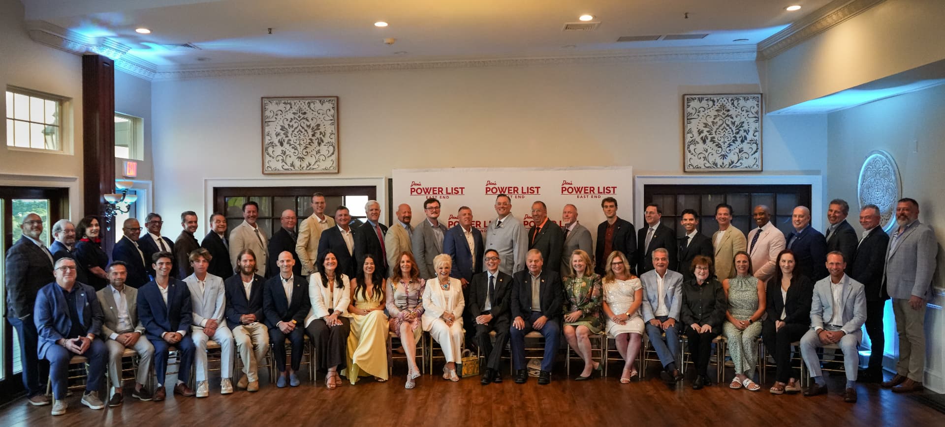 Power List honorees gathered for a group portrait in front of the Dan's Power List backdrop