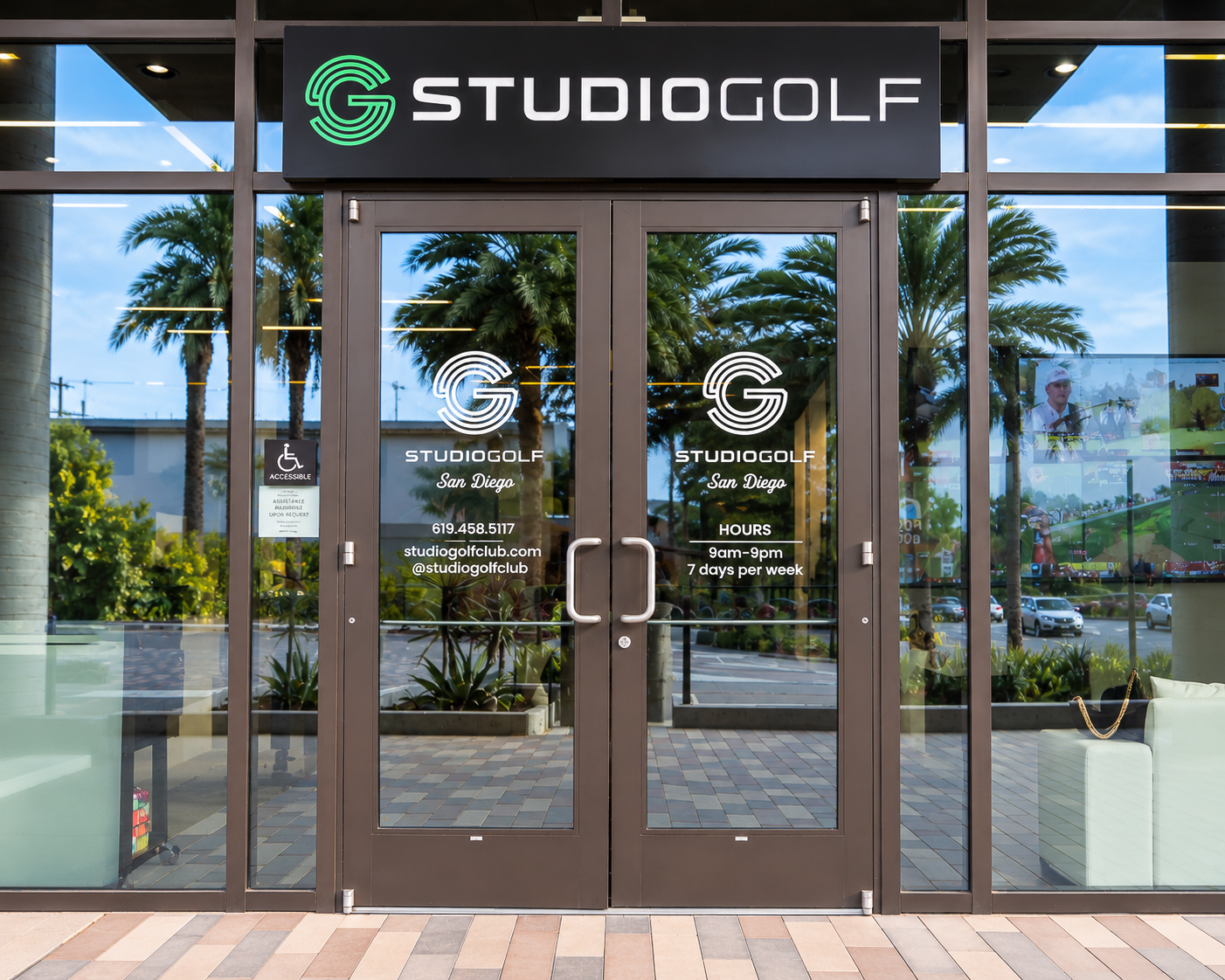 StudioGolf San Diego entrance framed by palm reflections