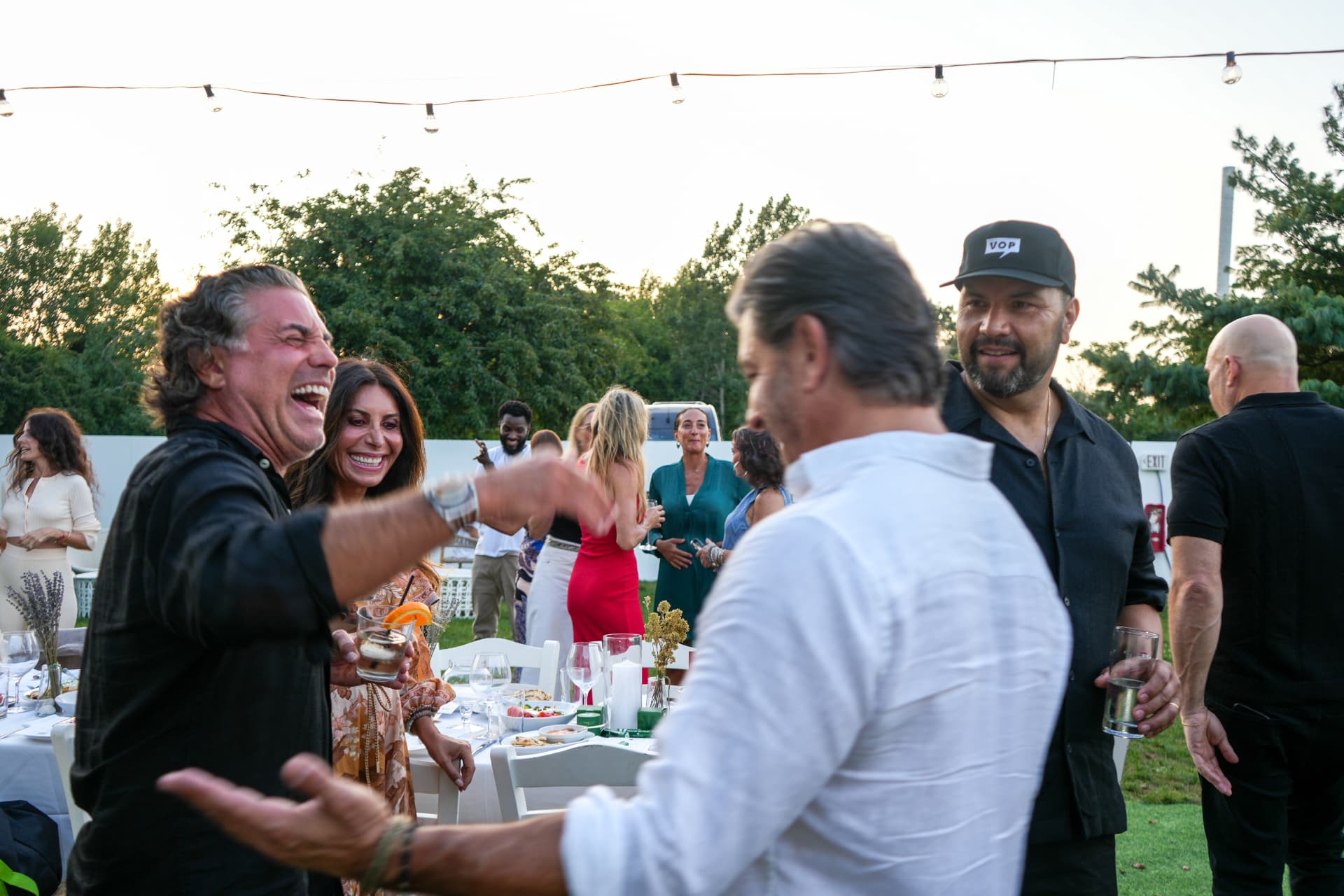 Guests greeting each other and laughing during cocktail hour
