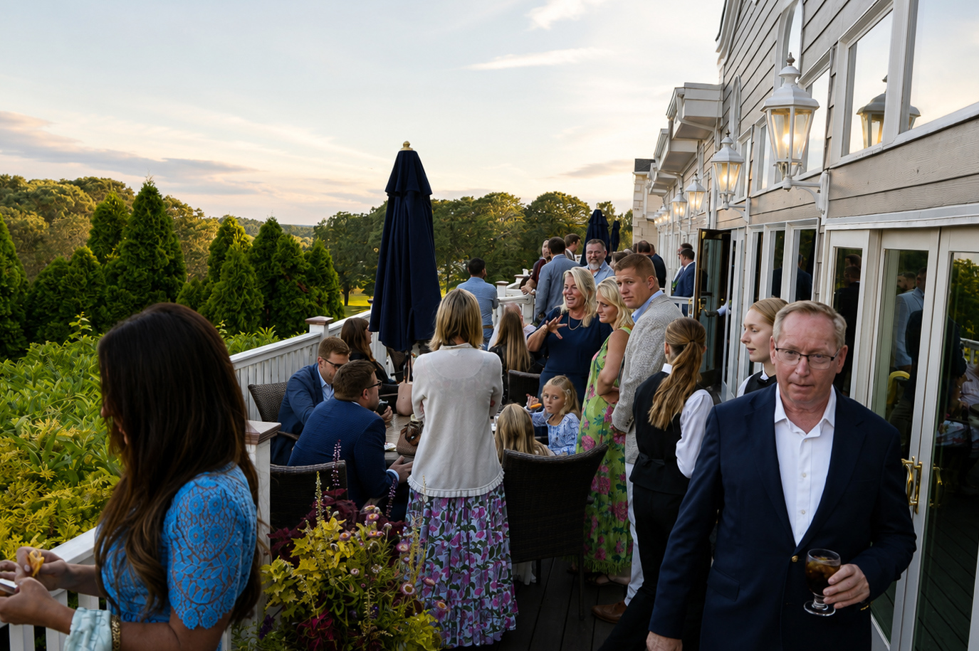 Cocktail hour on the terrace at golden hour overlooking the greens