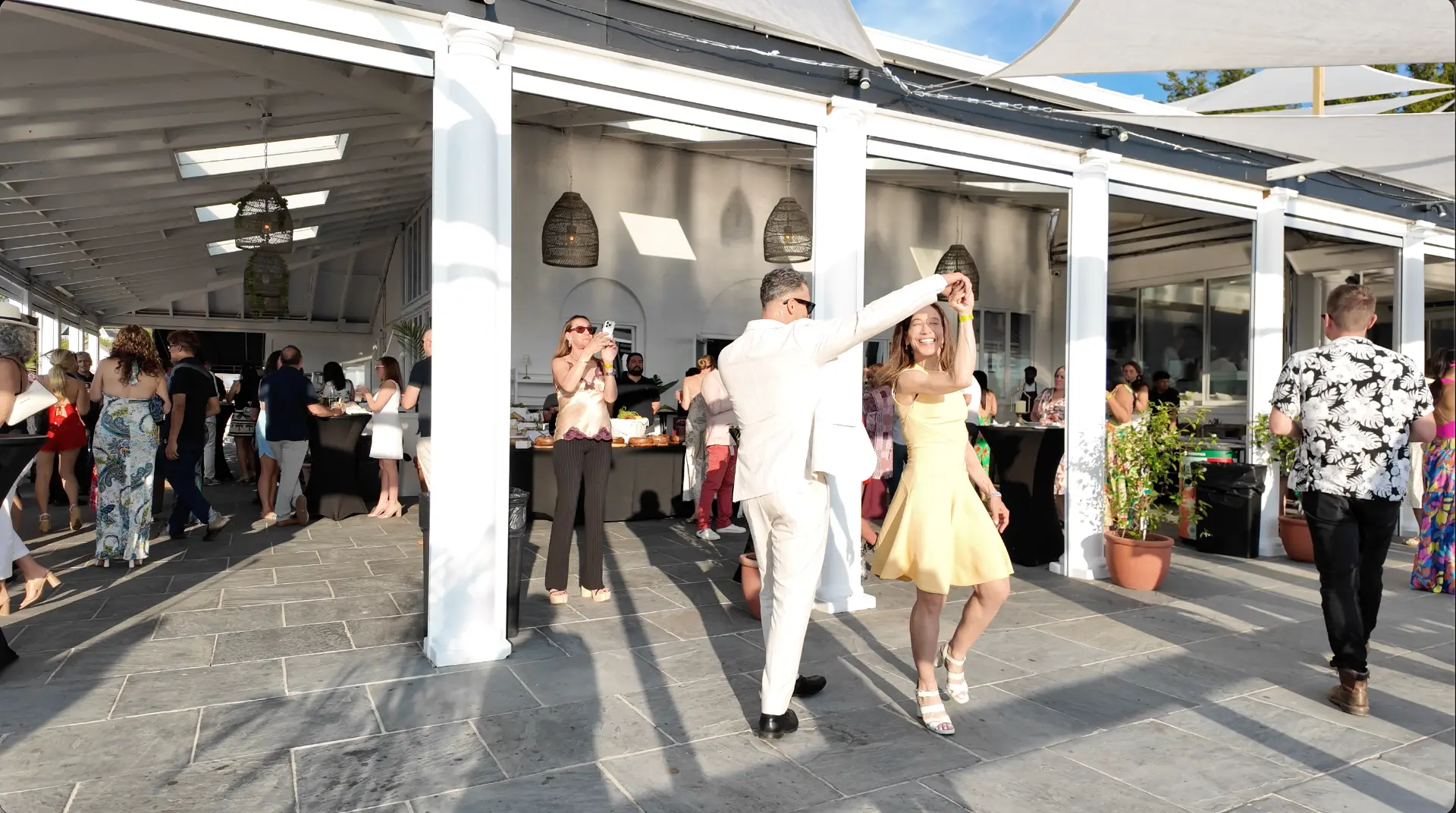 A couple dancing under the open-air pavilion during the party