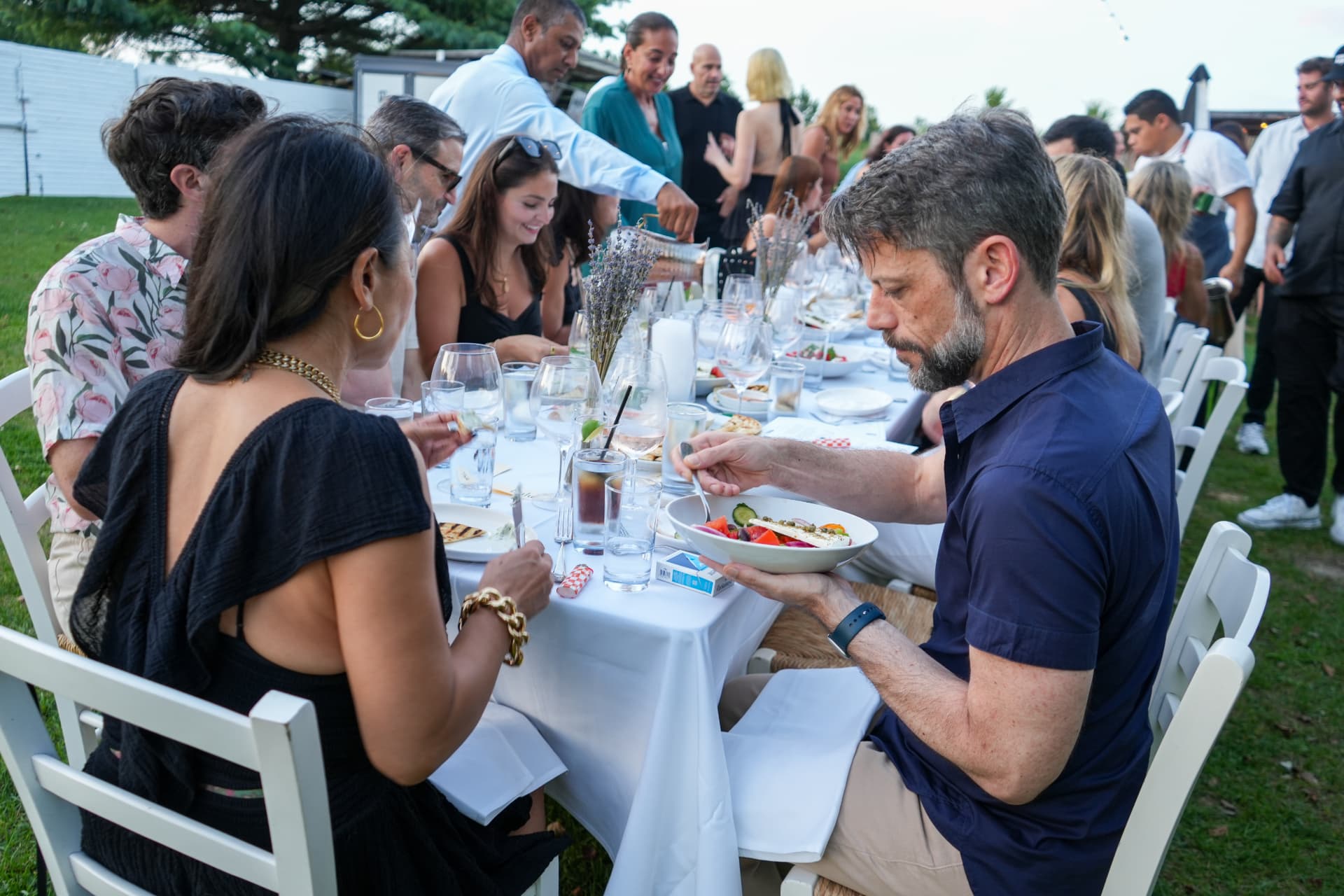 Guests seated along the long dinner table at the Hamptons brand dinner