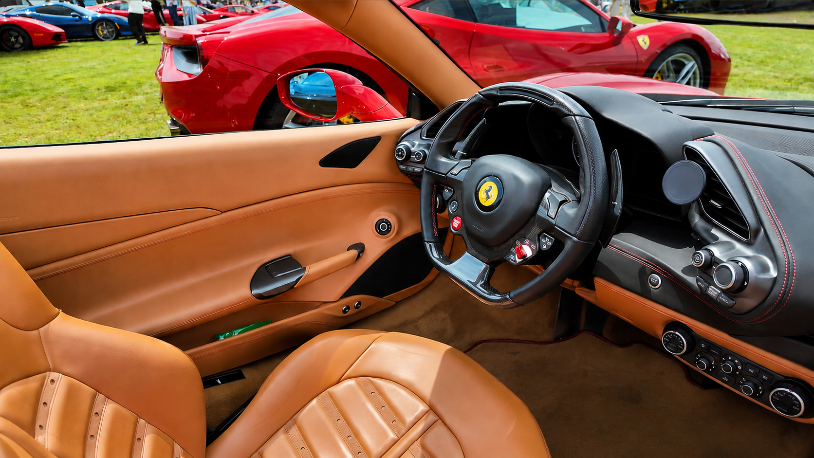 Tan leather Ferrari interior and steering wheel detail