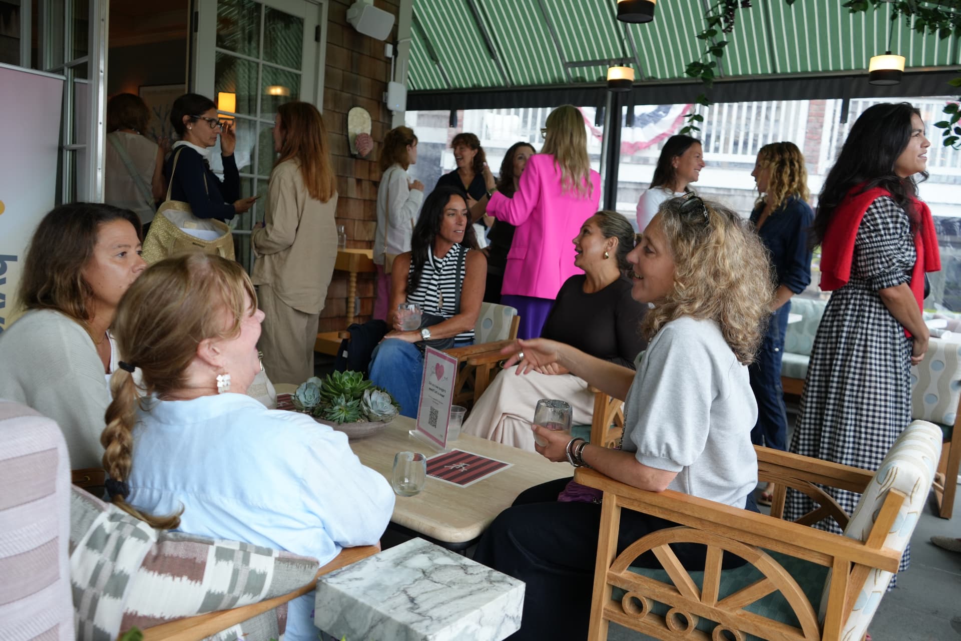 Guests seated in conversation across the garden lounge during the gathering