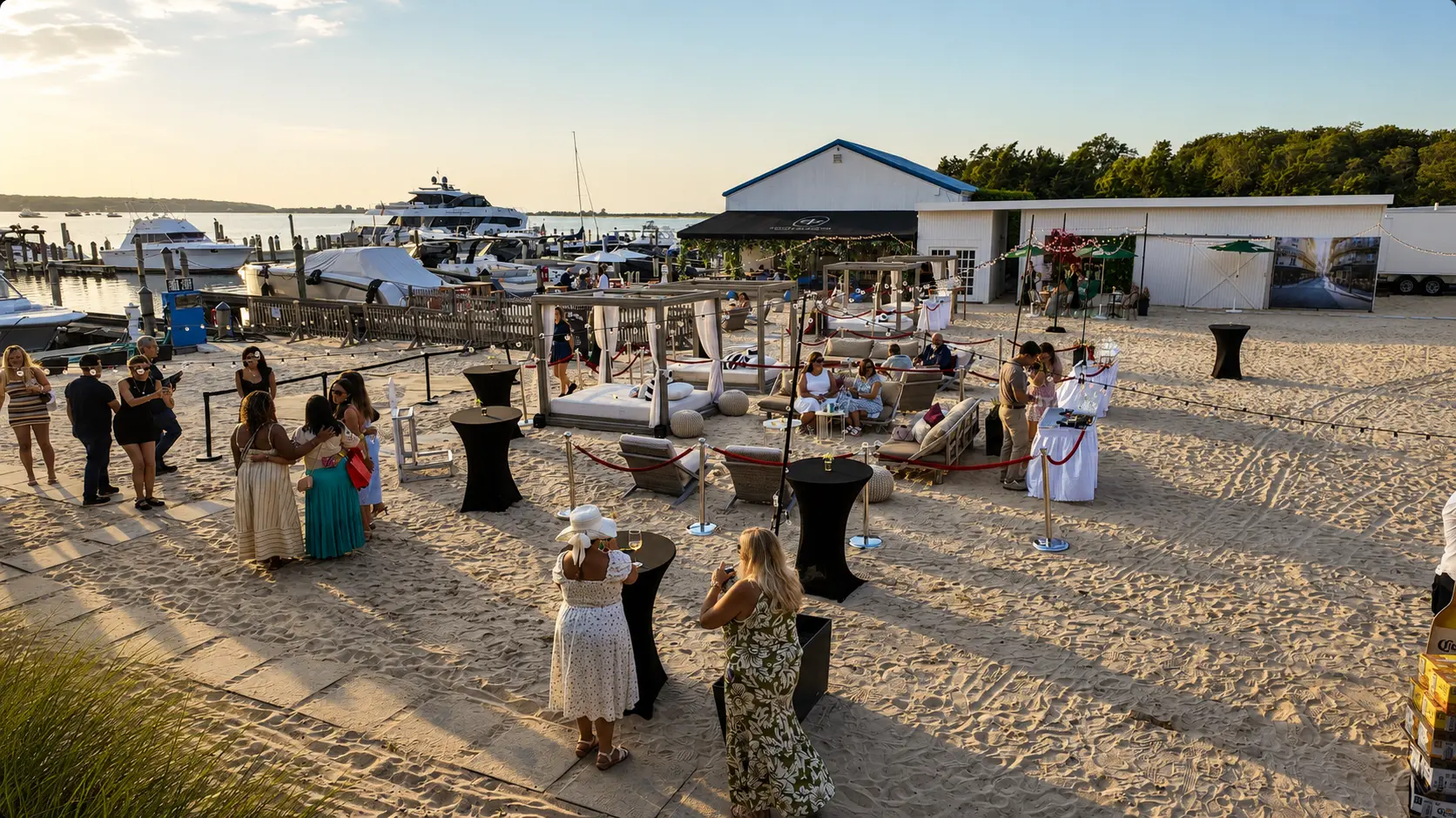 Guests gathered on the sand at Si Si at EHP Resort & Marina at golden hour