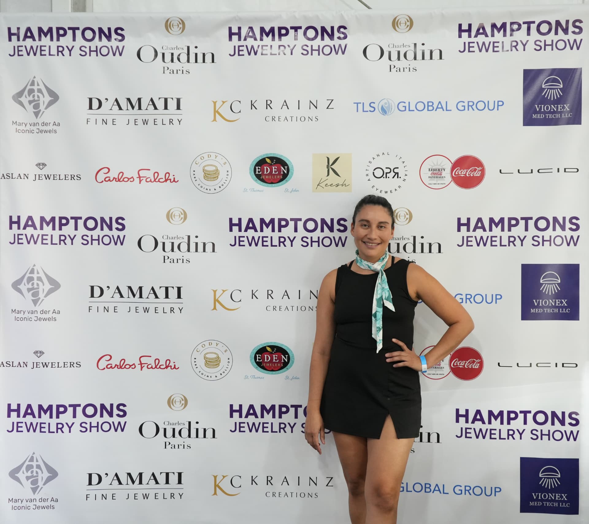 Guest photographed at the Hamptons Jewelry Show step-and-repeat backdrop