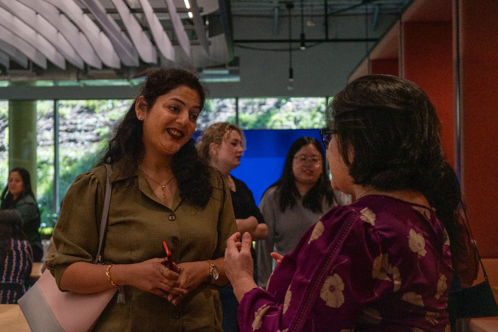 Attendees talking together during the Women in AI event