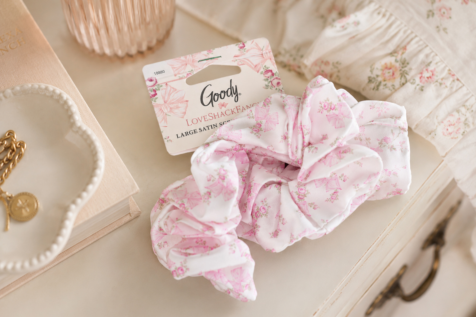Goody x LoveShackFancy satin scrunchie styled on a soft ivory vanity