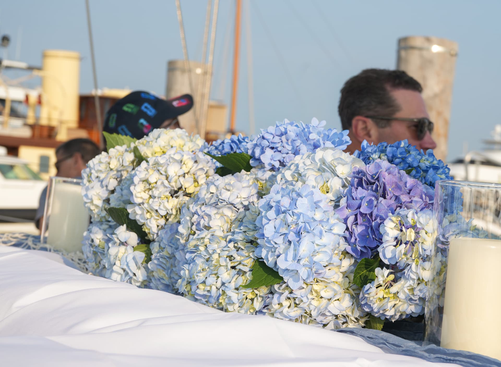 Blue and white hydrangea table runner with candles at the marina