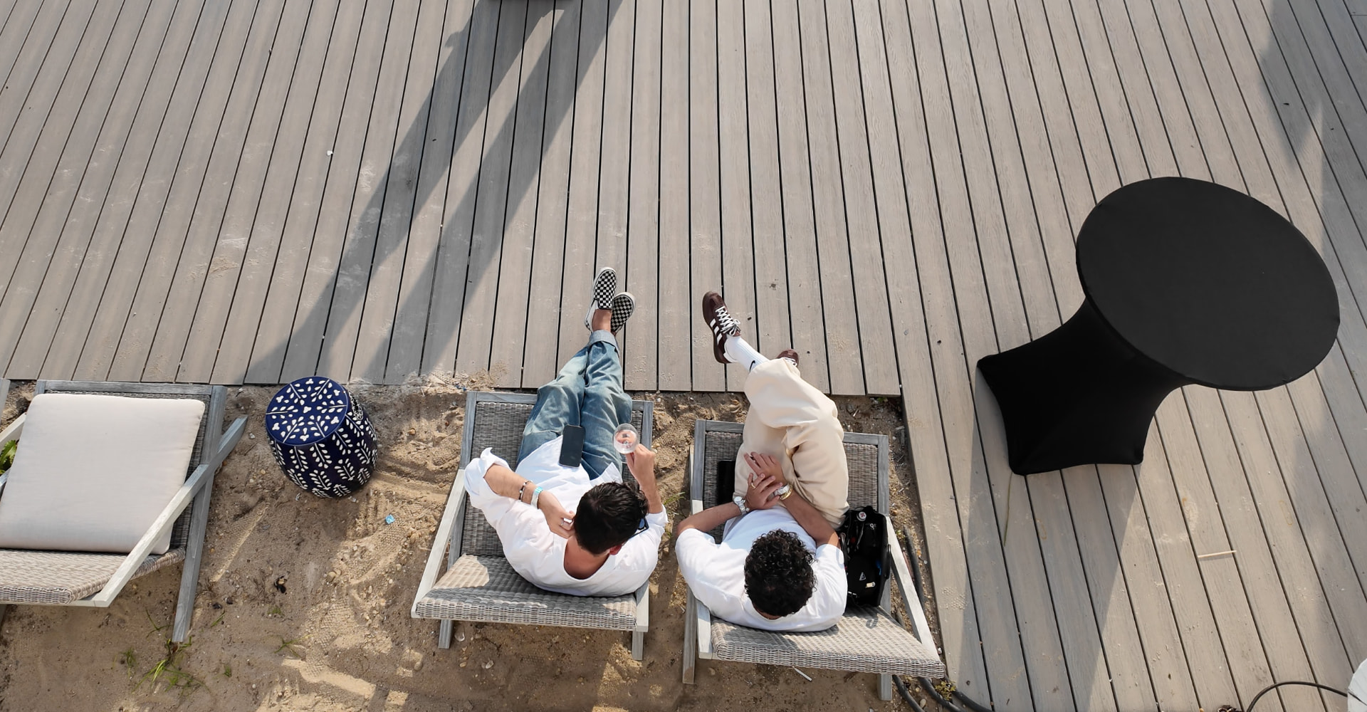 Overhead view of guests relaxing on loungers along the sand