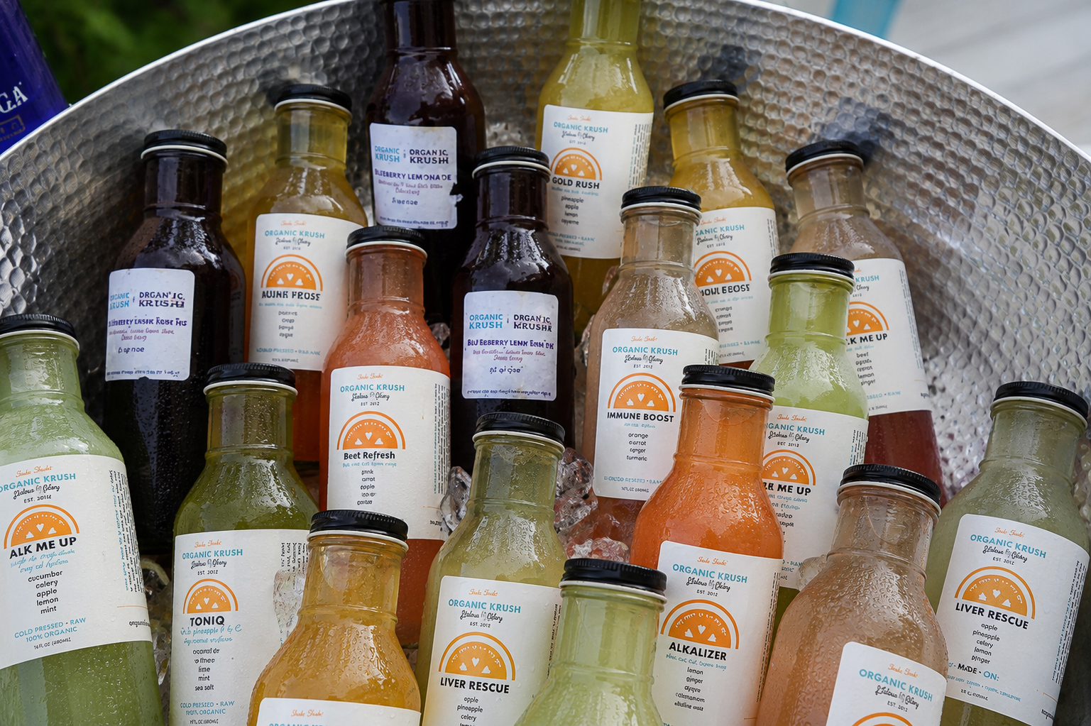 Organic Krush cold-pressed juices chilling on ice at the wellness activation